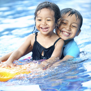 Two happy kids in a swimming pool