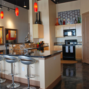 Kitchen area of loft-style apartment home at Block 24, with black appliances and pendant lightings