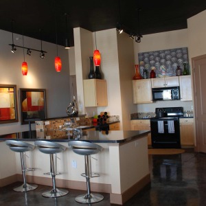 Kitchen area of loft-style apartment home at Block 24, with black appliances and pendant lightings