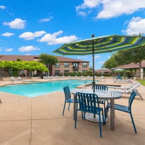 Block 24 Pool with Umbrella and chairs in forefront