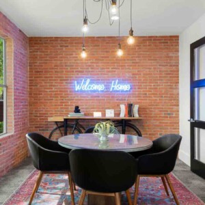 neon welcome home sign on brick wall