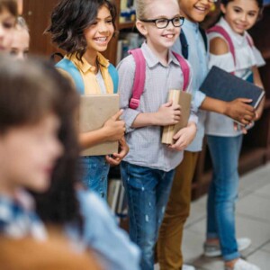 kids holding books at school